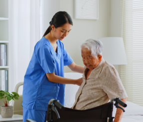 caregiver assessing the elderly in wheelchair