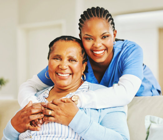 caregiver hugging the elderly woman