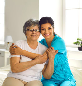 caregiver hugging the elderly woman