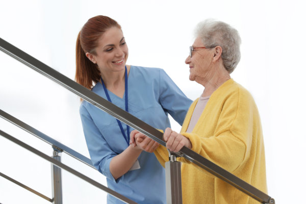 caregiver assessing the elderly woman